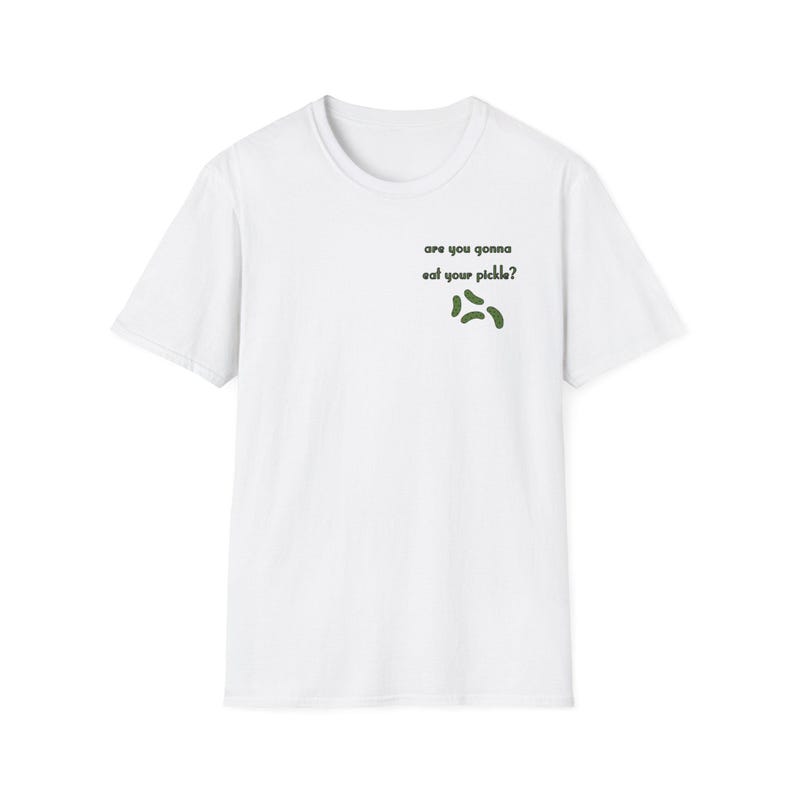 Peut inclure: T-shirt blanc avec l'inscription "are you gonna eat your pickle ?" en vert et trois illustrations de cornichons verts. Le t-shirt a des manches courtes et un col rond, id&eacute;al pour un look d&eacute;contract&eacute;.
