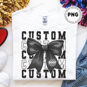 May include: White crew neck t-shirt with a large black bow graphic and the word "CUSTOM" repeated. The bow has a checkered circle with the word "MASCOT".