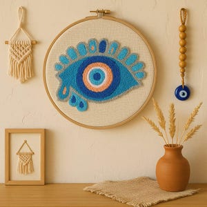 Evil Eye Wall Hanging Punch Needle Art – Handmade Blue Eye Embroidery in Hoop – Boho Fiber Art Decor for Living Room or Entryway