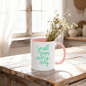 Pink accent coffee mug mockup styled on a rustic farmhouse kitchen counter with soft spring sunlight and wildflowers inside, Mother’s Day and Easter themed product photo.