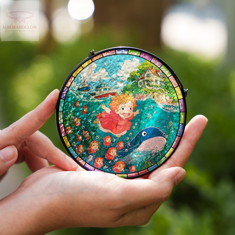 May include: A round stained glass art piece featuring a vibrant illustration of a girl in a red dress, a whale, and boats in the ocean. The artwork is framed with a black border and a colorful edge. The logo "AURORAHOLLOW" is in the upper left corner.
