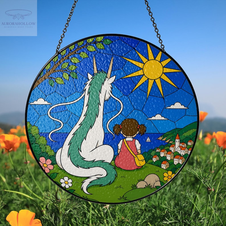 May include: Round stained glass window art featuring a scene with a white and green dragon, a girl in a red dress, and a coastal village under a bright yellow sun. The artwork is framed in black and hangs from a chain.