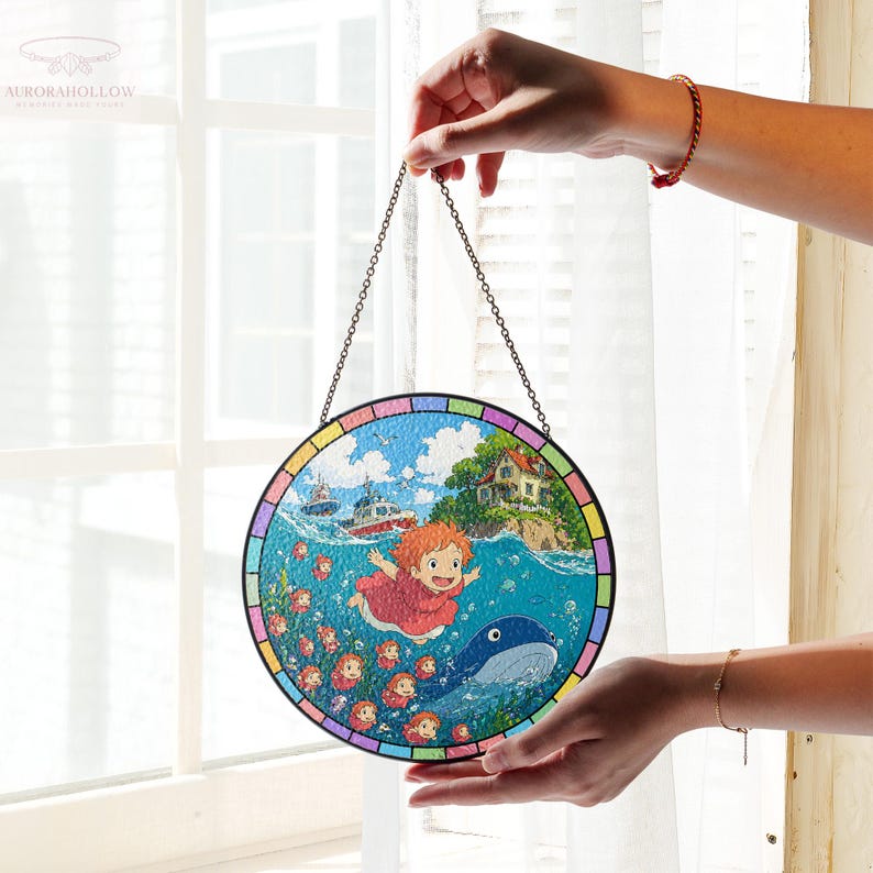May include: A round stained glass panel featuring a vibrant ocean scene with a red-haired character, boats, and a whale. The artwork is framed with a colorful border and suspended by a chain.