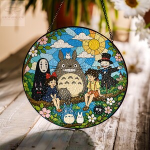 May include: Round stained glass panel featuring characters from a popular animated film. The artwork depicts a sunny sky, characters, and floral elements. The panel is framed with a black border and includes a hanging chain.