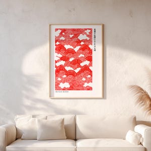 Puede incluir: Un cuadro enmarcado con un diseño de nubes y abanicos rojos y blancos. La impresión incluye texto japonés y el nombre "MATSUO BASHO" en texto blanco. La obra de arte se presenta en un marco dorado.