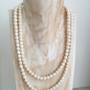 Ivory, white pearls round shape, lovely lustre. with a silver lobster clasp closure. Shown are 2 sets of pearl necklaces of differing sizes.