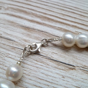 Ivory, white pearls round shape, lovely lustre. with a silver lobster clasp closure.