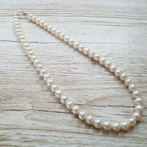 Ivory, white pearls round shape, lovely lustre. with a silver lobster clasp closure.