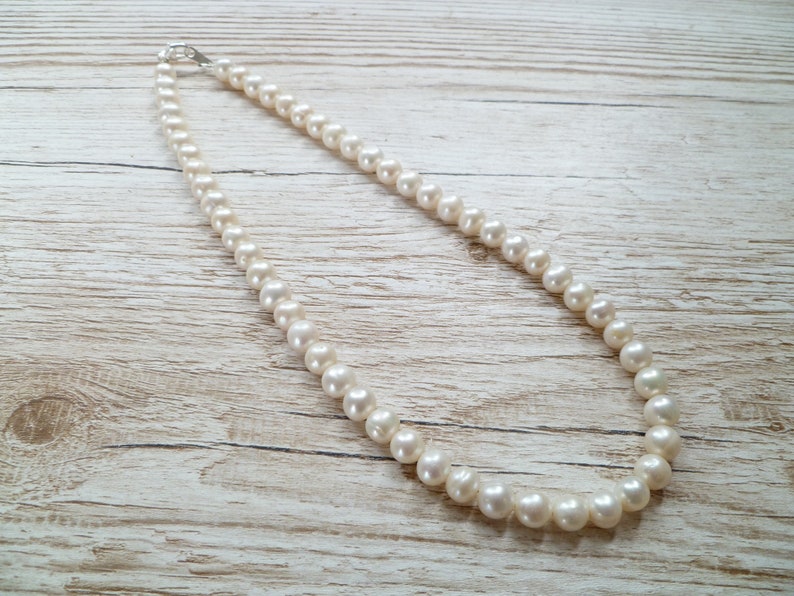 Ivory, white pearls round shape, lovely lustre. with a silver lobster clasp closure.