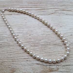 Ivory, white pearls round shape, lovely lustre. with a silver lobster clasp closure.