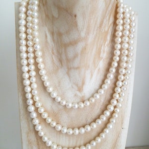 Ivory, white pearls round shape, lovely lustre. with a silver lobster clasp closure. Shown are 3 sets of pearl necklaces of differing sizes.