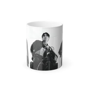 May include: White ceramic mug featuring a black and white image of a person in a leather jacket and pants, posing with a motorcycle. The mug has a glossy finish and a standard handle.