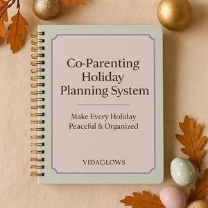 May include: A spiral-bound notebook with the text "Co-Parenting Holiday Planning System" in a decorative frame. The notebook is light green with gold spiral binding. The text "Make Every Holiday Peaceful & Organized" is also visible.