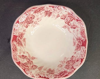 May include: A cream-colored ceramic bowl with a scalloped edge and a red transferware pattern. The rim features a detailed botanical design of strawberries, leaves, and small flowers, leaving the center of the bowl plain and white.