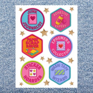 May include: A sheet of six circular and hexagonal stickers with colorful borders and gold star accents. The stickers feature text including Junk Journalist, Adhesive Expert, Paper Scrap Saver, Ephemera Collector, Sticker Hoarder, and Washi Tape Wizard.