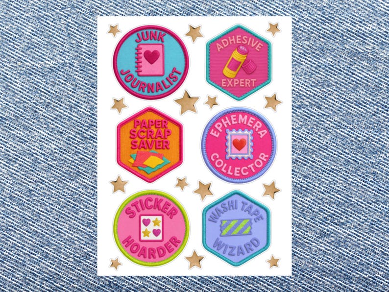 May include: A sheet of six circular and hexagonal stickers with colorful borders and gold star accents. The stickers feature text including Junk Journalist, Adhesive Expert, Paper Scrap Saver, Ephemera Collector, Sticker Hoarder, and Washi Tape Wizard.