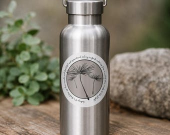 May include: A stainless steel water bottle with a silver finish and a metal carrying handle on the cap. A circular sticker on the front features a black line drawing of dandelion seeds on a light gray background with circular text.