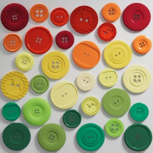May include: An assortment of colorful buttons in shades of red, orange, yellow, and green. The buttons vary in size and style, with two or four holes. Some buttons have textured designs.