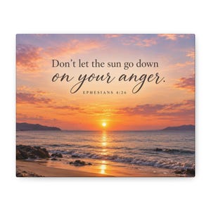May include: A rectangular wall art print featuring a sunset over the ocean with waves washing onto a sandy beach. The text "Don't let the sun go down on your anger. EPHESIANS 4:26" is printed in dark brown letters across the center of the sky.