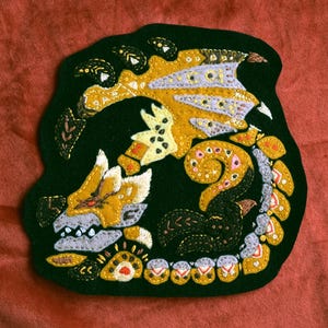 Gold rathian embroidered patch