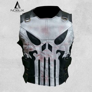 May include: A white and black vest with a skull design. The vest has black accents, straps, and pockets. The skull design is centered on the front of the vest. The vest is made of a leather-like material.