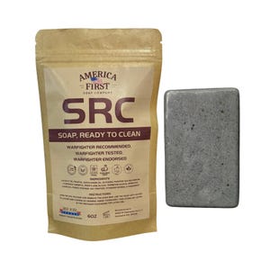 Könnte beinhalten: Ein brauner Beutel mit SRC-Seife und eine graue Seifenstück. Der Beutel trägt die Aufschrift "SRC SOAP, READY TO CLEAN" von America First Soap Company. Das Seifenstück ist rechteckig, grau mit dunklen Flecken.