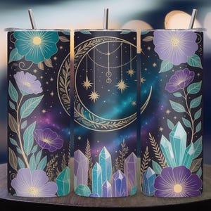 May include: A stainless steel tumbler with a celestial design. The tumbler features a crescent moon, stars, and crystals against a galaxy background. Floral accents in teal and purple adorn the sides. Includes a silver straw.