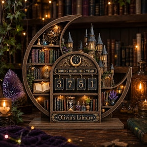 May include: A crescent moon-shaped wooden bookshelf display featuring a miniature castle, illuminated shelves with books, an hourglass, and a mechanical counter with the text "BOOKS READ THIS YEAR" and "3751" above a plaque reading "Olivia's Library."