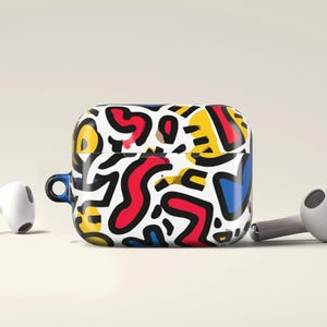 May include: Wireless earbuds and a case with a vibrant abstract design. The case has a pattern of red, yellow, blue, and black shapes on a white background. The earbuds are positioned near the case, showcasing a modern aesthetic.
