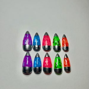 May include: Ten lava lamp-style nail art designs. Each nail features a silver base and a translucent, teardrop-shaped top in colours like purple, blue, red, green, and orange. The designs are arranged in two rows of five.