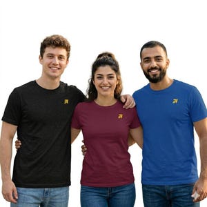 May include: Three people wearing short-sleeved t-shirts in black, burgundy, and blue. Each shirt has a small gold logo on the left chest. The people are smiling and standing close together.