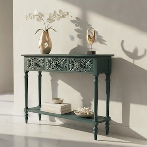 May include: A white ceramic mug with a black handle and the text "But First, Coffee" in a black, bold font. The mug is on a white surface.