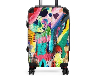 May include: A black rolling suitcase with a colorful abstract design. The design features bright colors like pink, yellow, blue, green, and red. The suitcase has a retractable handle and four wheels.