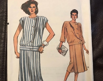 May include: A sewing pattern for a dress and jacket. The pattern is for sizes 8-10-12. The dress is striped and has a button-up front. The jacket is solid brown and has a button-up front. The pattern is called "Very Easy Very Vogue" and the pattern number is 9310.