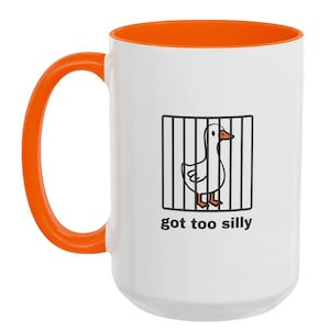 May include: White ceramic mug with an orange handle and interior. The mug features a cartoon goose behind bars with the text "got too silly" in black. A fun and whimsical design for a coffee or tea lover.