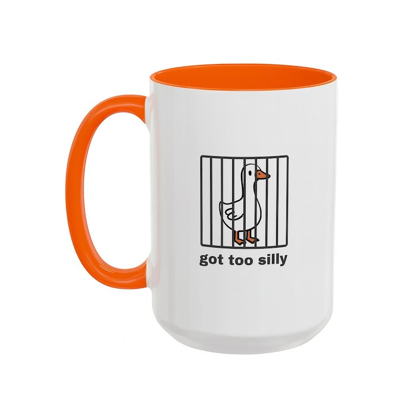 May include: White ceramic mug with an orange handle and interior. The mug features a cartoon goose behind bars with the text "got too silly" in black. A fun and whimsical design for a coffee or tea lover.