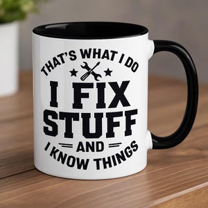 May include: White ceramic mug with a black interior and handle. The mug features the text "THAT'S WHAT I DO I FIX STUFF AND I KNOW THINGS" in black, along with a wrench and star graphic.