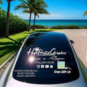 May include: A silver car with a black roof and a decal that reads "High Printed Graphics." The decal also includes social media icons and the text "Custom-Made Decals: Select Your Size, Color, and Fonts."
