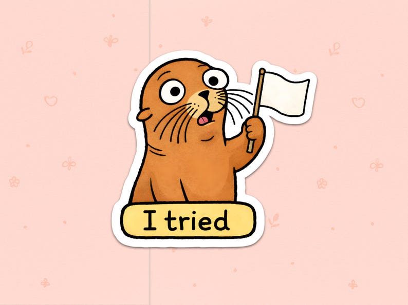 May include: A sticker of a cartoon seal, brown with large eyes, holding a white flag. The text "I tried" is below the seal on a yellow background. The sticker is set against a pink background with small floral patterns.