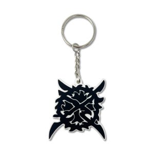 May include: A black and white keychain featuring a stylized, symmetrical design. The keychain has a silver-colored ring and chain. The design is a geometric shape with pointed edges and a central cross-like element. The keychain is likely made of a durable material.