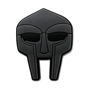 May include: A black, stylized mask with a geometric design. The mask features a rectangular face with a prominent nose and two eye openings. The mask is a solid color with a matte finish.