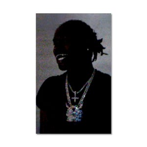 May include: Silhouette of a person wearing two diamond-encrusted necklaces. The necklaces feature a cross pendant and a large, ornate pendant. The person is smiling, with their teeth visible. The background is a muted gray.