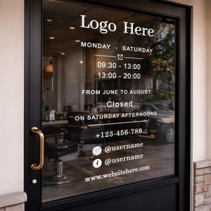 May include: Black door with gold handle displaying business hours and contact information. Text includes "Logo Here", operating hours, and social media handles. The door is made of black material and has a glass panel.