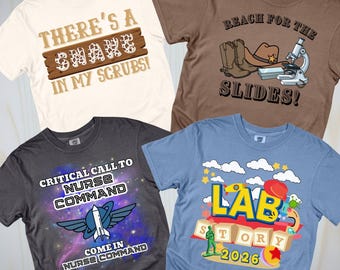 May include: Four t-shirts with humorous medical and science-themed graphics. One shirt is cream-colored with the text "THERE'S A SNAKE IN MY SCRUBS!". Another is brown with "REACH FOR THE SLIDES!". A gray shirt says "CRITICAL CALL TO NURSE COMMAND". A blue shirt says "LAB STORY 2026".