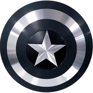 May include: A round shield with a black central area and outer ring, with a silver star at the centre. The shield has silver bands and a black border. The design is reminiscent of a superhero's iconic shield.