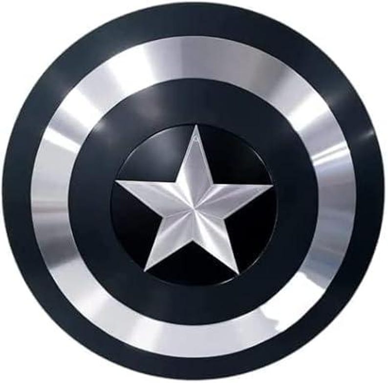 May include: A round shield with a black central area and outer ring, with a silver star at the centre. The shield has silver bands and a black border. The design is reminiscent of a superhero's iconic shield.
