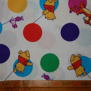 Winnie the Pooh cotton fabric BTY Rainbow Pooh balloon tigger piglet white brightly colored red yellow blue green purple flying nursery