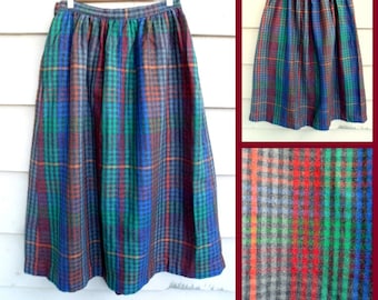 May include: A full-length plaid skirt with a gathered waist. The skirt is made of a thick, woven fabric and has a blue, green, red, and gray plaid pattern.