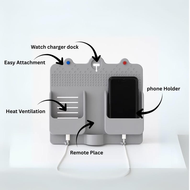 May include: A grey charging station with a phone holder, watch charger dock, and remote place. The station has easy attachment and heat ventilation features. A black smartphone is in the phone holder, and white charging cables are connected.