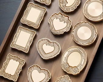 May include: An assortment of gold-coloured decorative trays in different shapes, such as rectangular, oval, and heart designs. The trays have detailed floral and scrollwork patterns, presented on a wooden tray. The overall style is vintage and elegant, with each tray measuring approximately 10 cm.